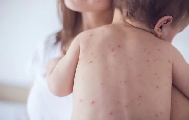 Mother nursing sick child At Home