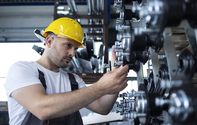 Industrial worker working at production line in factory.