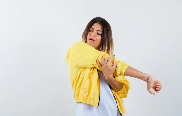 female in t-shirt, jacket stretching arms and looking relaxed , front view.