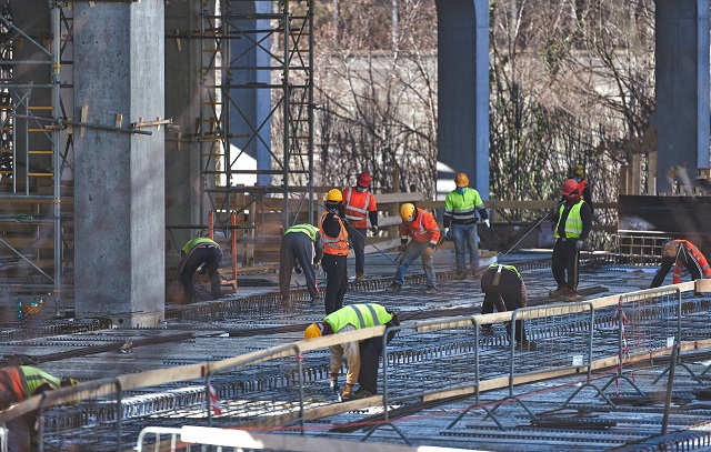 Construction workers on site with protective masks for covid 19