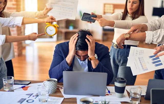 Group of business workers working together. Partners stressing one of them at the office