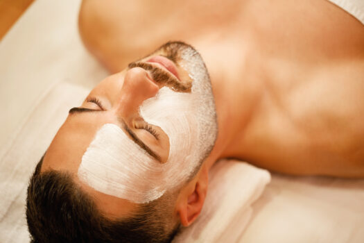 Relaxed man having facial treatment at the spa.
