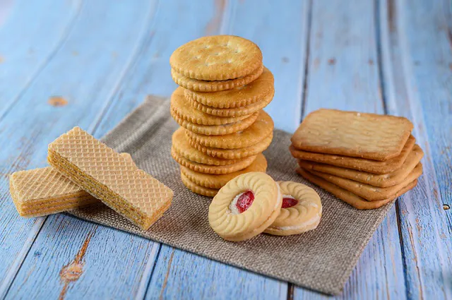 Many cookies are placed on the fabric and then placed on a wooden table.